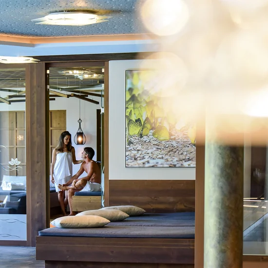 Entschleunigen und genießen in diesem Hotel nahe Bruneck Paar im Spa-Bereich mit Holzmöbeln und entspannter Atmosphäre